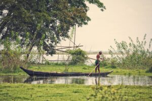 Fisherman navigating the Brahmaputra River during Assam floods
