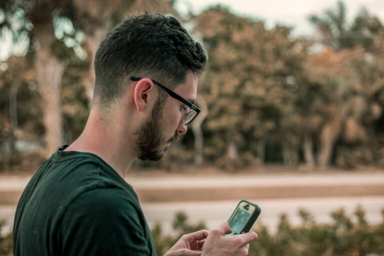person using mobile phone outdoors showing habits that affect focus and concentration