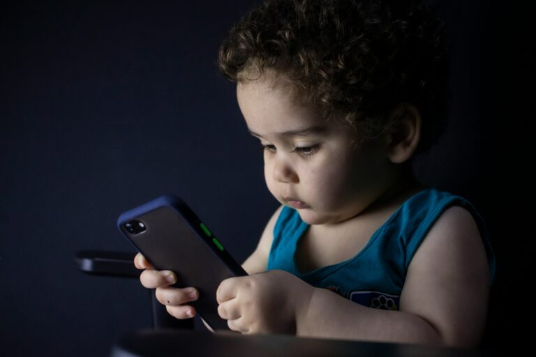 A child using a mobile phone alone, illustrating mobile addiction in children and excessive screen time.