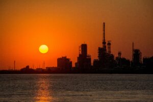 Industrial landscape at sunset symbolizing the future of oil and its role in shaping modern civilization and global energy systems.